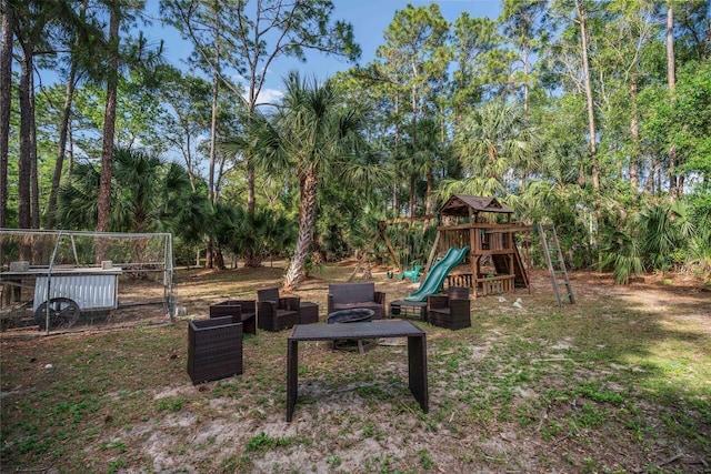 18292 126th Ter N, Jupiter, FL 33478 - view of yard with a playground and view of wooded area