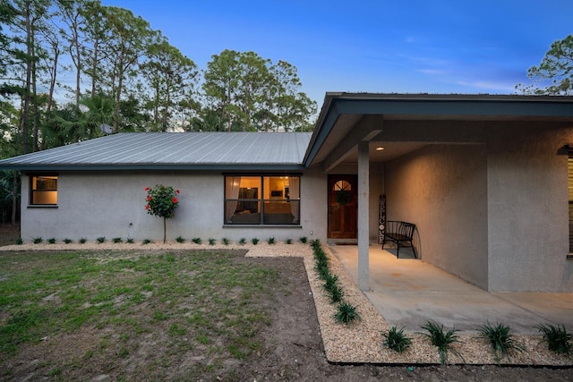18292 126th Ter N, Jupiter, FL 33478 - doorway to property with stucco siding and metal roof