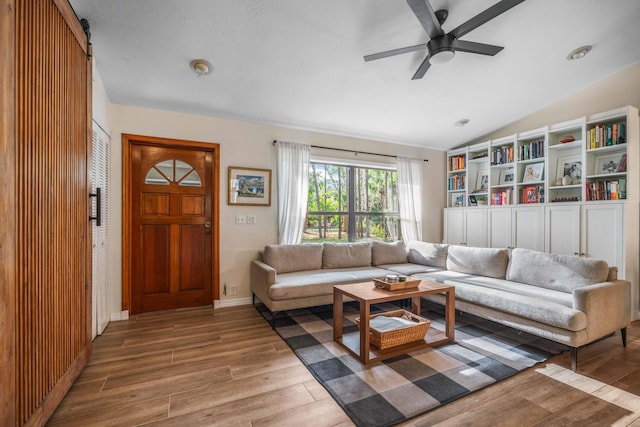 18292 126th Ter N, Jupiter, FL 33478 - living area featuring wood finished floors, vaulted ceiling, and ceiling fan