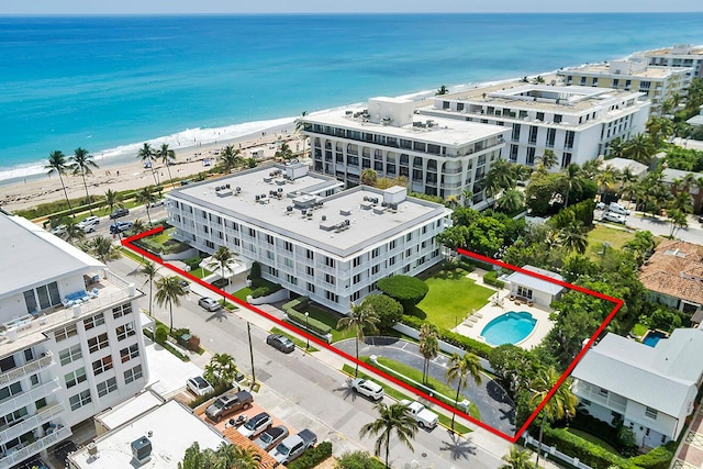 drone / aerial view with a beach view and a water view