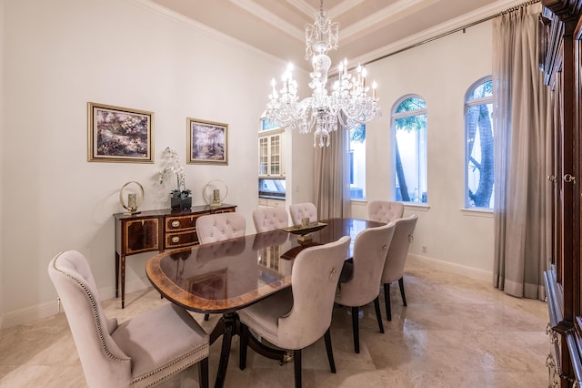 dining space with a wealth of natural light, a notable chandelier, baseboards, and ornamental molding