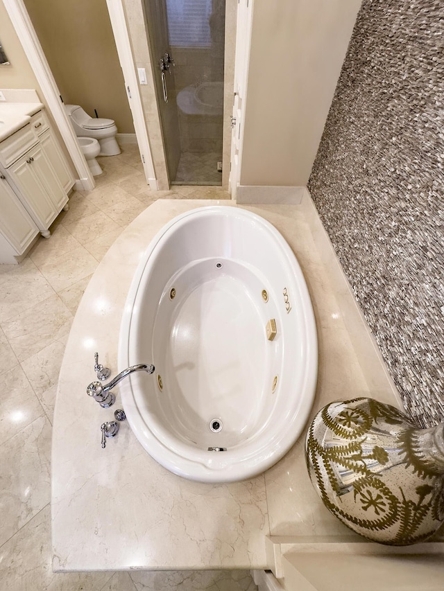 room details featuring toilet, a jetted tub, a stall shower, and vanity