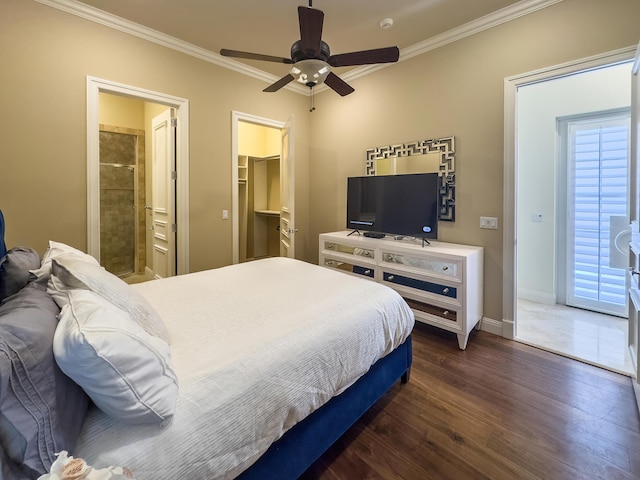 bedroom featuring ensuite bathroom, dark wood finished floors, ornamental molding, a spacious closet, and baseboards