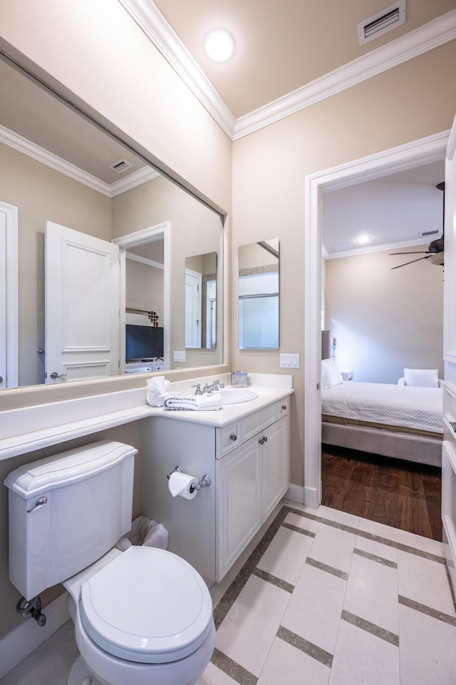 bathroom featuring visible vents, toilet, crown molding, connected bathroom, and vanity