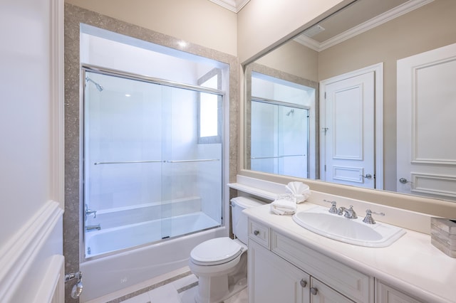 bathroom with ornamental molding, toilet, vanity, and bath / shower combo with glass door