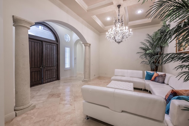 living room with a chandelier, arched walkways, decorative columns, and coffered ceiling