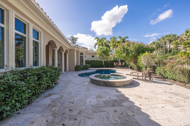 view of swimming pool with a patio area and fence