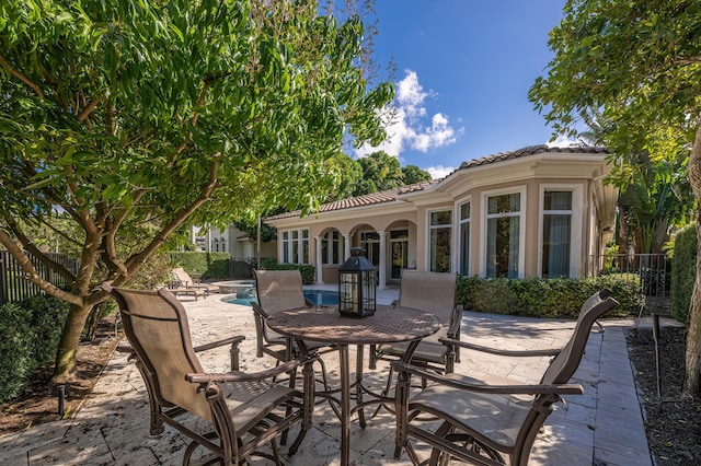 view of patio / terrace with fence, a fenced in pool, and outdoor dining area