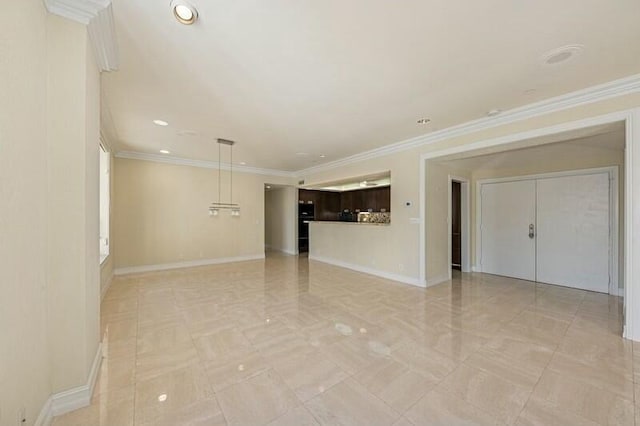 empty room featuring baseboards, ornamental molding, and recessed lighting
