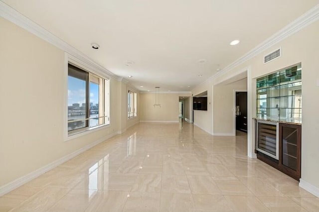 interior space featuring baseboards, ornamental molding, and visible vents