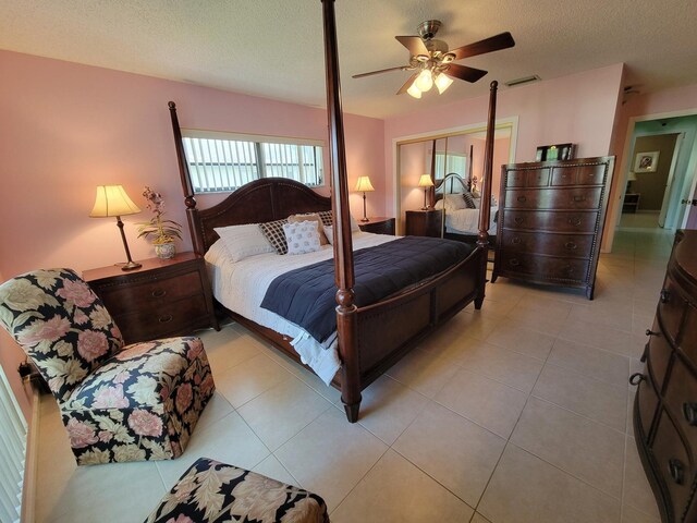 4941 Dovewood Rd Unit A, Boynton Beach, FL 33436 - bedroom with tile patterned flooring, visible vents, a textured ceiling, and a ceiling fan