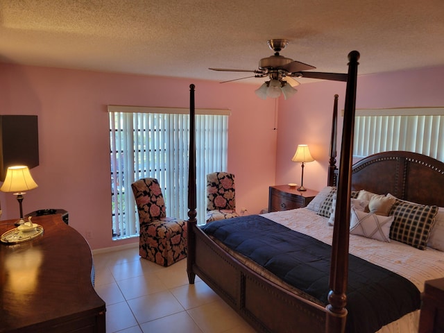 4941 Dovewood Rd Unit A, Boynton Beach, FL 33436 - bedroom featuring a textured ceiling, light tile patterned floors, baseboards, and multiple windows