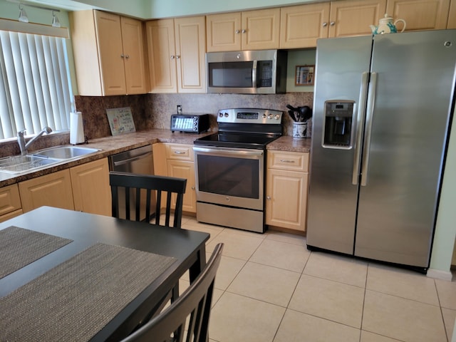 4941 Dovewood Rd Unit A, Boynton Beach, FL 33436 - kitchen with light tile patterned floors, light brown cabinetry, a sink, stainless steel appliances, and decorative backsplash