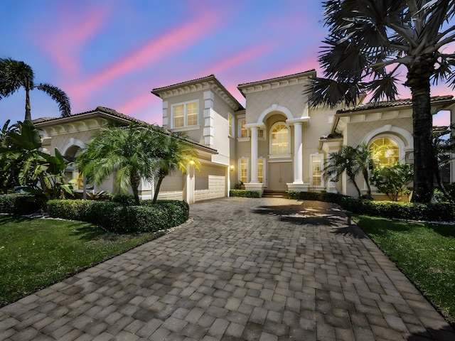 17384 Vistancia Cir, Boca Raton, FL 33496 - mediterranean / spanish house featuring driveway, stucco siding, and an attached garage