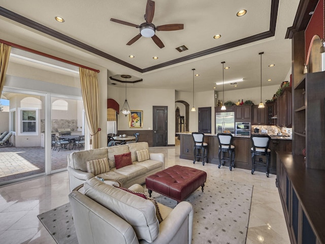 17384 Vistancia Cir, Boca Raton, FL 33496 - living room with a tray ceiling, arched walkways, ornamental molding, a ceiling fan, and visible vents