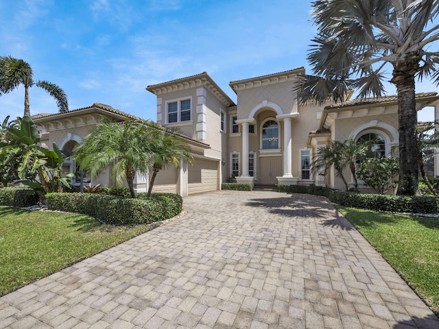 17384 Vistancia Cir, Boca Raton, FL 33496 - mediterranean / spanish-style house with a garage, stucco siding, and decorative driveway