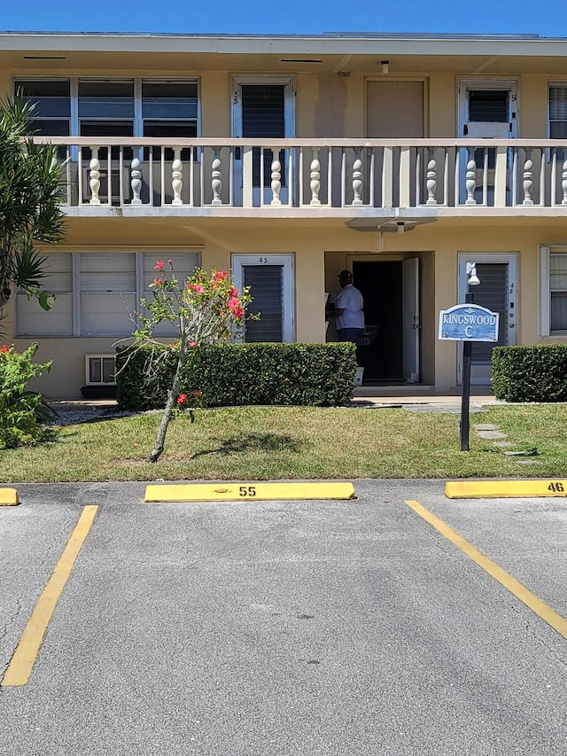 view of building exterior featuring uncovered parking