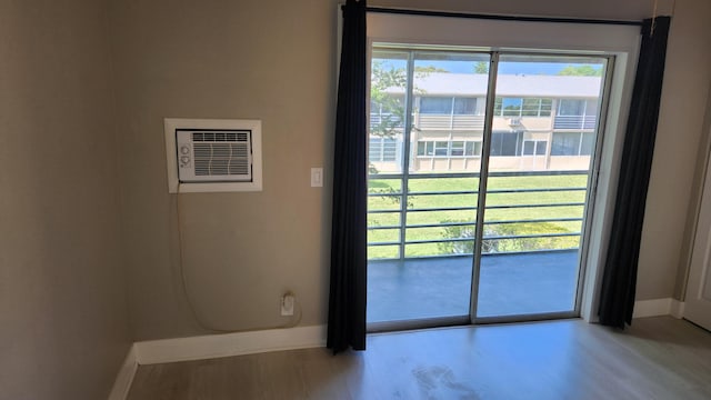 entryway featuring wood finished floors, baseboards, and plenty of natural light