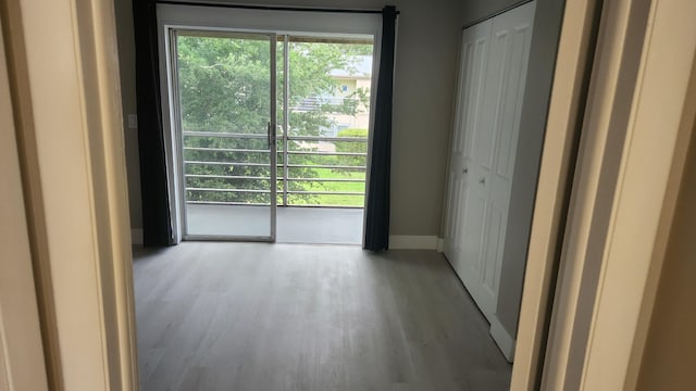 empty room with baseboards and wood finished floors