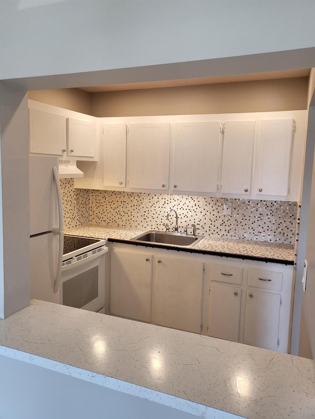 kitchen with range hood, tasteful backsplash, a sink, white appliances, and white cabinetry