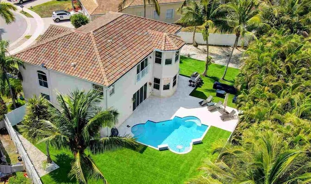 aerial view of property and surrounding area featuring a pool