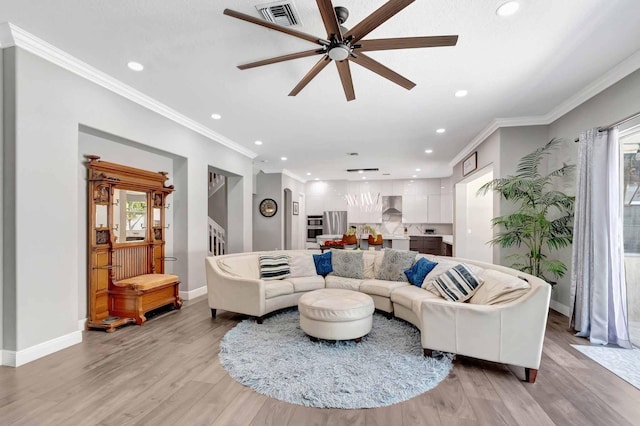 living area featuring recessed lighting, baseboards, a ceiling fan, light wood finished floors, and ornamental molding
