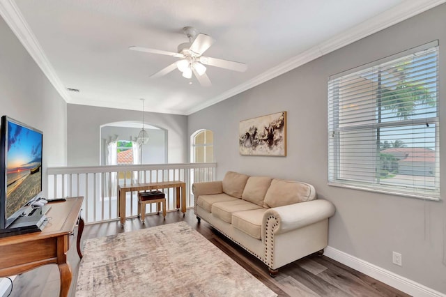living area featuring ceiling fan, crown molding, wood finished floors, baseboards, and an office area