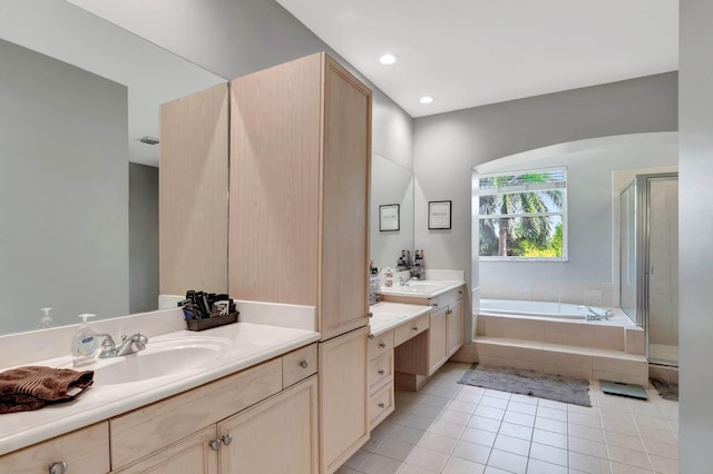 full bath with tile patterned floors, a garden tub, a shower stall, two vanities, and recessed lighting