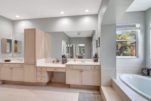 full bathroom with a garden tub, vanity, tile patterned flooring, and recessed lighting