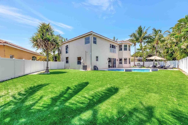 rear view of property featuring stucco siding and central air condition unit