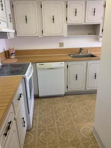 1905 NW 18th St Unit 101, Delray Beach, FL 33445 - kitchen with white appliances, a sink, under cabinet range hood, and open shelves