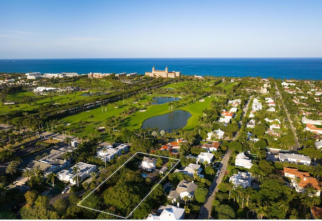 drone / aerial view featuring a residential view, a water view, and golf course view