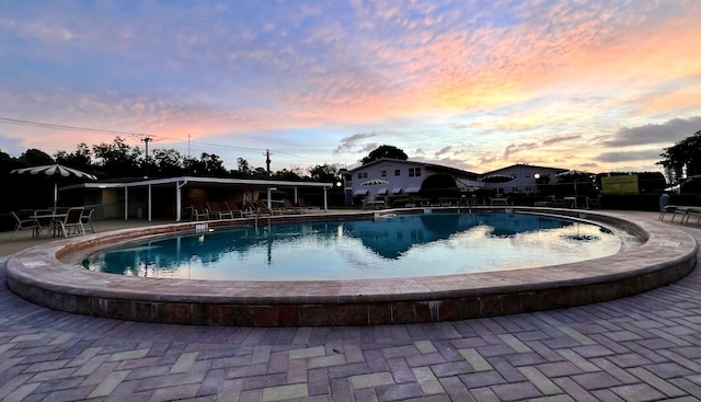 135 Dorchester F, West Palm Beach, FL 33417 - pool at dusk with a patio