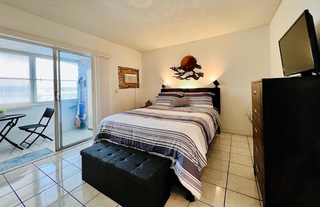 135 Dorchester F, West Palm Beach, FL 33417 - bedroom with access to exterior, a textured ceiling, and light tile patterned flooring
