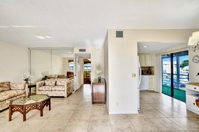 475 Piedmont J, Delray Beach, FL 33484 - living area with light tile patterned floors and visible vents