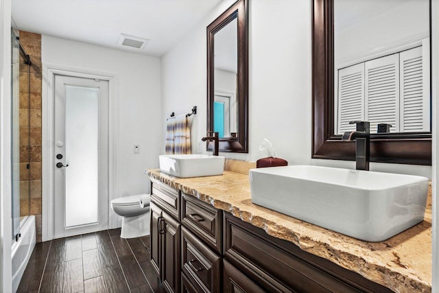 21786 Banyanwood Rd, Boca Raton, FL 33433 - bathroom featuring visible vents, wood finished floors, toilet, and a sink