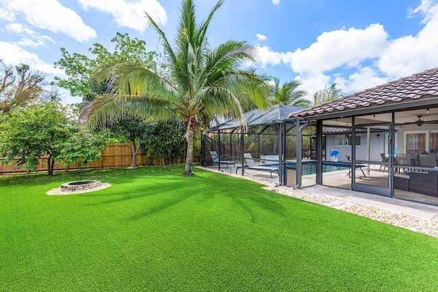 21786 Banyanwood Rd, Boca Raton, FL 33433 - view of yard with an outdoor fire pit, a fenced backyard, a fenced in pool, a patio area, and a lanai