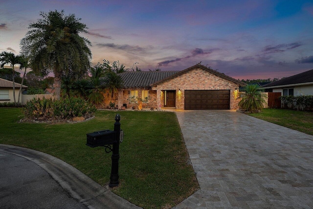 21786 Banyanwood Rd, Boca Raton, FL 33433 - ranch-style house with stone siding, a front lawn, decorative driveway, and an attached garage