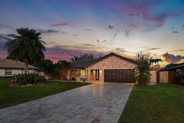 21786 Banyanwood Rd, Boca Raton, FL 33433 - ranch-style home featuring a garage, a lawn, decorative driveway, stone siding, and fence