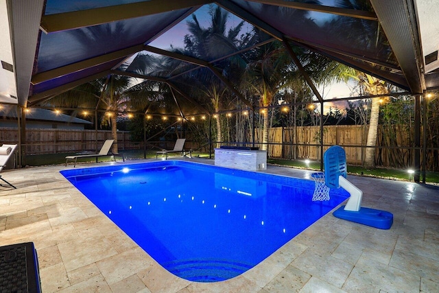 21786 Banyanwood Rd, Boca Raton, FL 33433 - view of swimming pool featuring glass enclosure, a fenced in pool, a fenced backyard, and a patio area