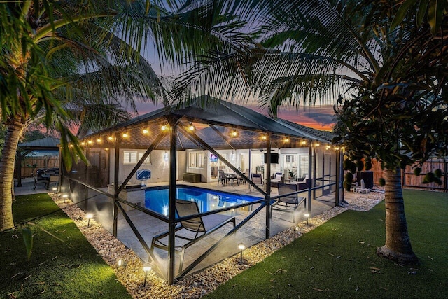 21786 Banyanwood Rd, Boca Raton, FL 33433 - pool at dusk with fence, a fenced in pool, and a patio area