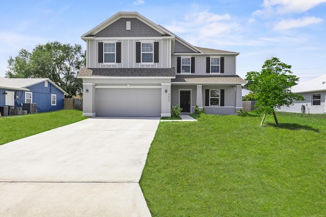 view of front of home featuring roof with shingles, driveway, cooling unit, an attached garage, and a front lawn