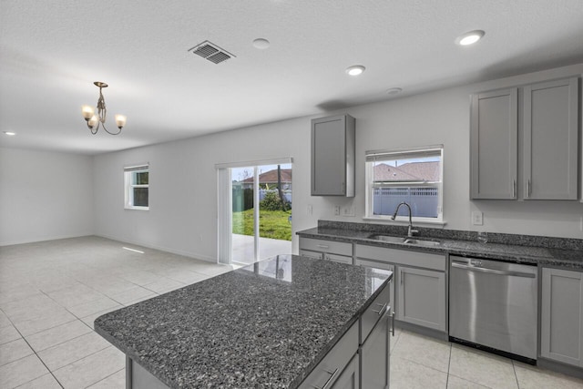 kitchen featuring a sink, gray cabinets, and stainless steel dishwasher