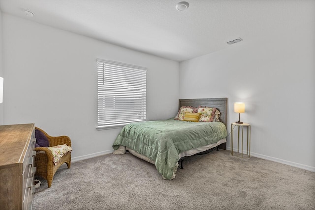 bedroom with carpet, visible vents, and baseboards