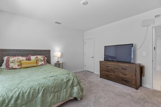 bedroom with visible vents, baseboards, and carpet flooring