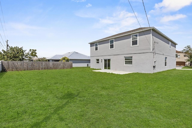 back of house featuring a patio area, fence, and a lawn