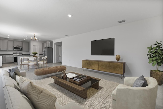 living area featuring light tile patterned flooring, an inviting chandelier, visible vents, and recessed lighting