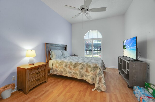 bedroom with lofted ceiling, visible vents, a closet, baseboards, and light wood-style flooring