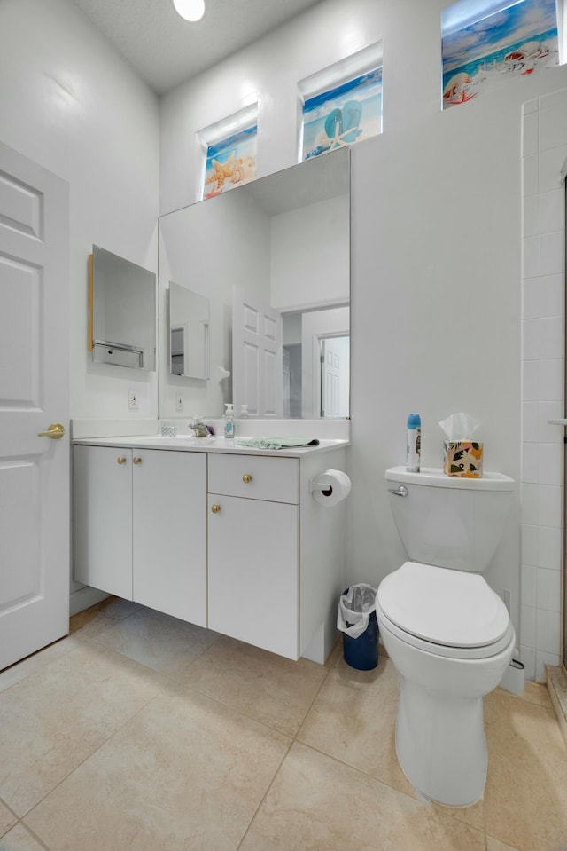 bathroom featuring toilet, a stall shower, visible vents, tile patterned flooring, and vanity