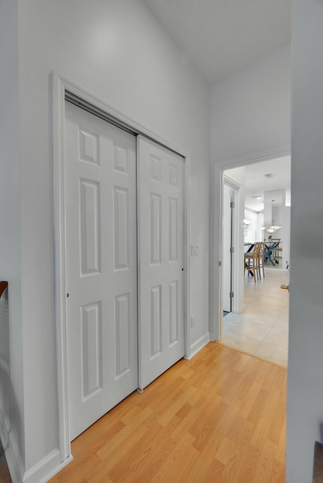 bedroom with baseboards, a ceiling fan, and light wood-style floors